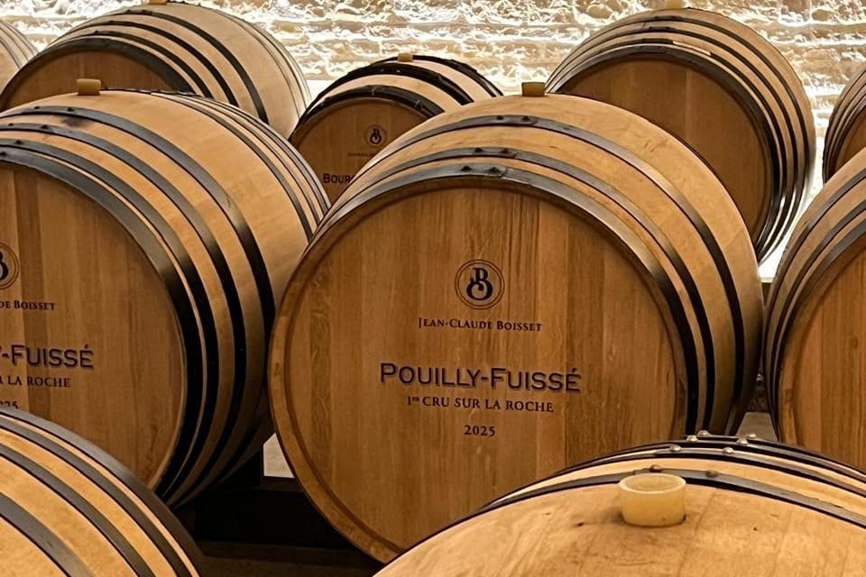 Barricas de carvalho marcadas Pouilly-Fuissé empilhadas em adega